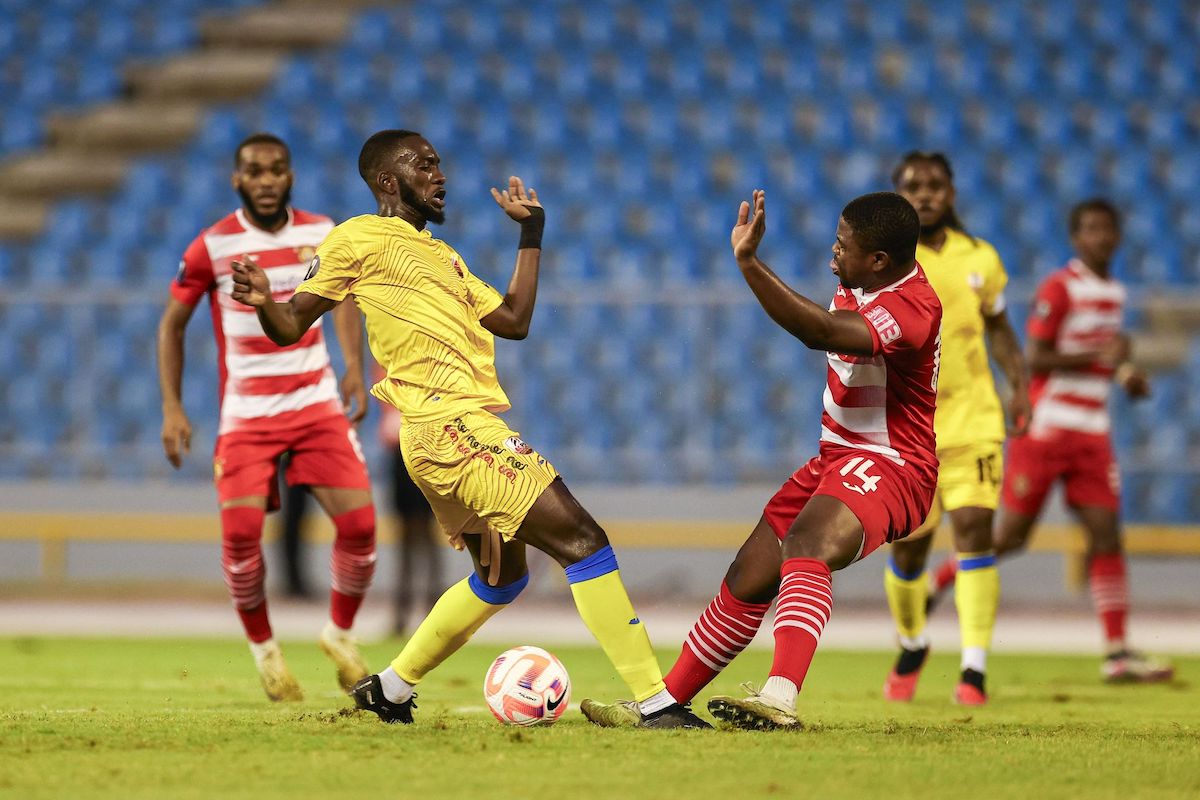 AC Port of Spain's Anthony Charles, left, battles for possession with Golden Lions FC's Johann Noel during the Concacaf Caribbean Cup match at the Hasely Crawford Stadium in Port-of-Spain on Wednesday, September 20th 2023. AC PoS suffered a 3-2 loss. PHOTO: Daniel Prentice