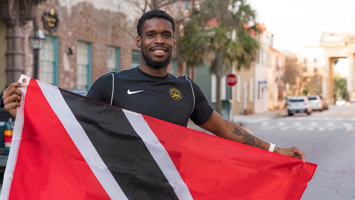 Charleston Battery’s Leland Archer with the flag of his home country, Trinidad and Tobago