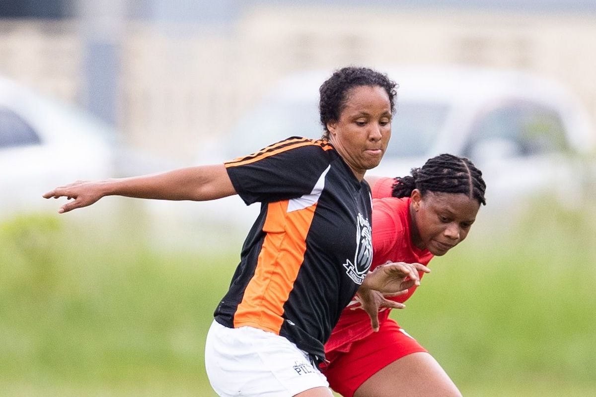 Midfielder Maylee Attin-Johnson, left, of Trincity Nationals holds off the challenge from La Horquetta Rangers Women Leah Massiah during the TT Wolf Ascension Tournament at Eddie Hart Grounds on Sunday, July 17th 2022 in Tacarigua. Rangers won 3-1. (Photo by Daniel Prentice)