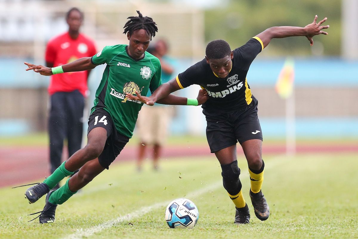 Carapichaima East Secondary attacker Josiah Hypolite, left, jostles with Miracle Ministries High’s Daniel Hope for possession during the Secondary School Football League’s Central Zone Intercol match at the Ato Boldon Stadium in Balmain, Couva on Monday, November 14th 2022. Carapichaima won 6-1. (Photo by Daniel Prentice)