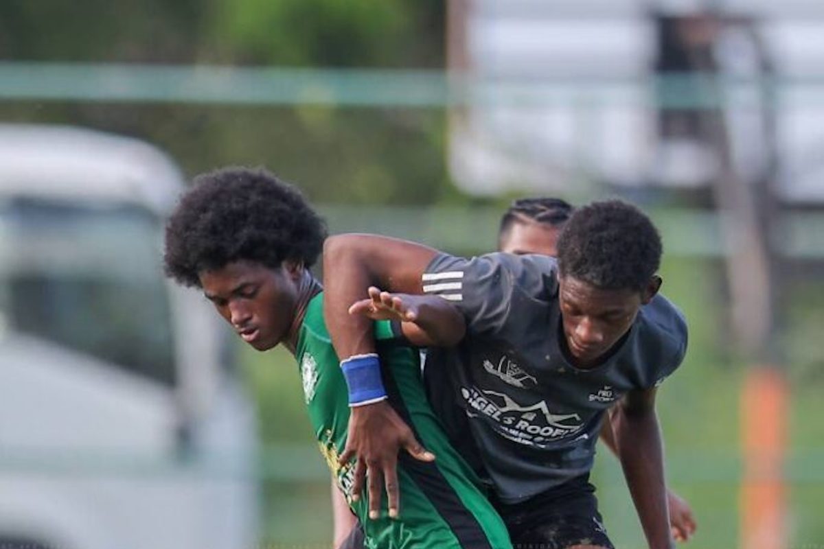 Carapichaima East's Thiam Agard, left, battles Miracle Ministries’ Keon Codrington for the ball during the Coca-Cola Central Zone Intercol semifinal at Edinburgh 500 grounds, Chaguanas on November 14th 2023. PHOTO BY: Daniel Prentice