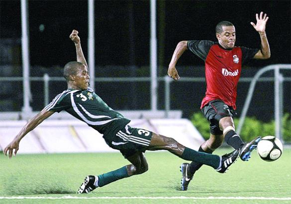 W Connection’s Kern Cupid, left, puts in a stretching tackle on bmobile Joe Public’s Hayden Tinto in their Digicel Pro League “Big Six” match at the Marvin Lee Stadium, Macoya on Tuesday night. With the 0-0 result, Joe Public added the “Big Six” to its league crown. Photos: Anthony Harris