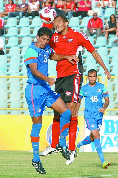 India’s Raju Gaikwad (3) and T&T’s Darryl Roberts in an aerial battle during yesterday’s friendly international at the Hasely Crawford Stadium. Roberts scored a double as T&T won 3-0. (PHOTO: TT Guardian).