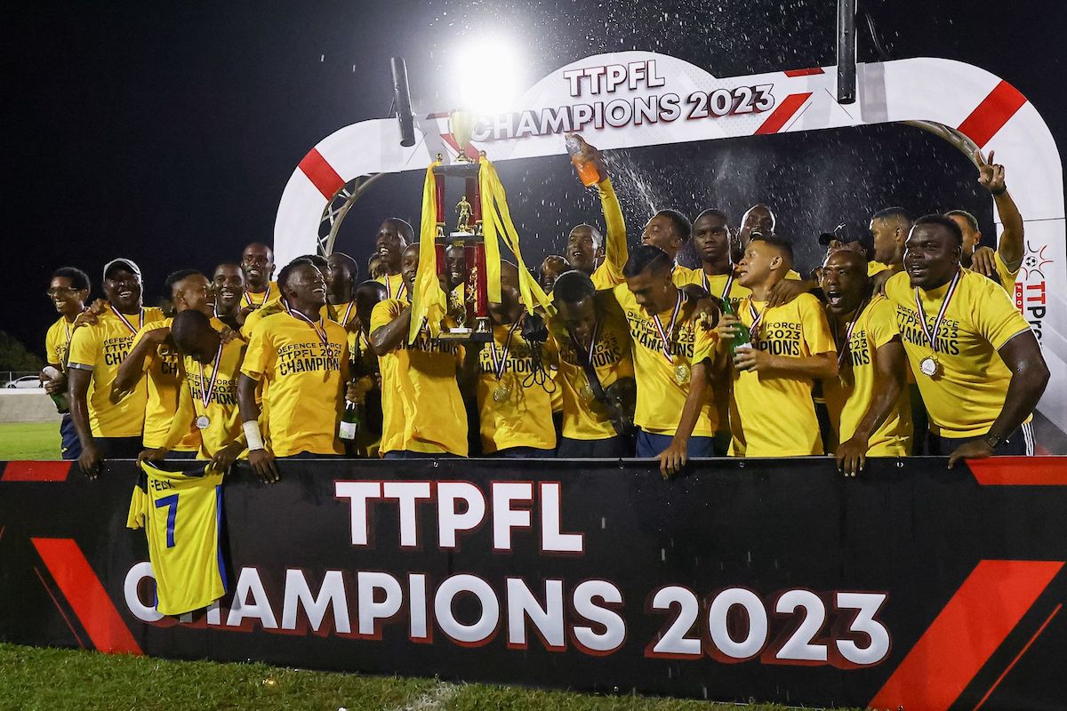 Players and support staff of Defence Force FC celebrate with the winners trophy after defeating AC POS in the T&T Premier Football League match at the Arima Velodrome, Arima on Saturday, June 24th 2023. Defence Force finish with 56 points ahead of AC POS’ 55 points. PHOTO: Daniel Prentice