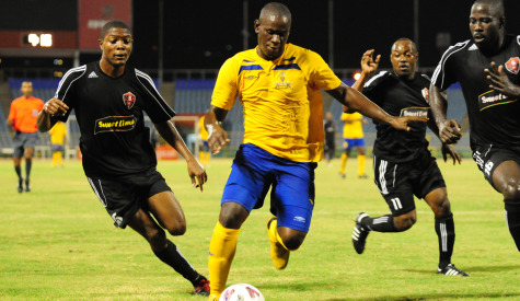 Defence Force inform striker Devon Jorsling (in yellow) on the attack.