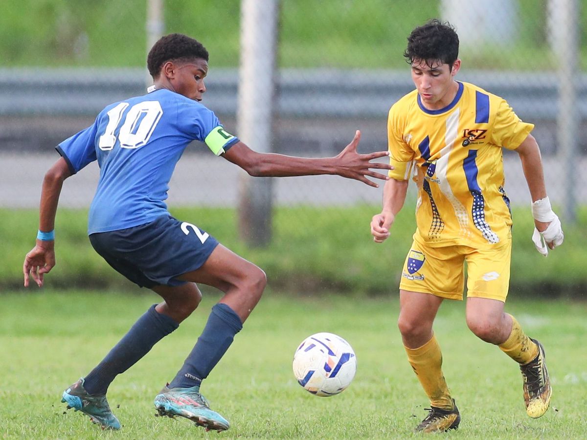 Fatima's Seth Hadeed, right, tries to get by opposing captain of QRC, Phillip Nelson, to keep possession during the Secondary School Football League North Zone Under-14 match at the Hasely Crawford Training Field, Mucurapo on Tuesday, November 1st 2022. Seth scored the winner in Fatima's 3-2 win. (Photo by Daniel Prentice)