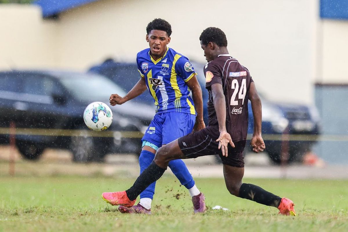 Fatima College winger Christian Bailey, left, slips a pass past East Mucurapo's defender Khufu Muhammad during the Secondary Schools Football League match at the Fatima College grounds in Port-of-Spain on Wednesday, September 20th 2023. Fatima won 5-0. PHOTO: Daniel Prentice