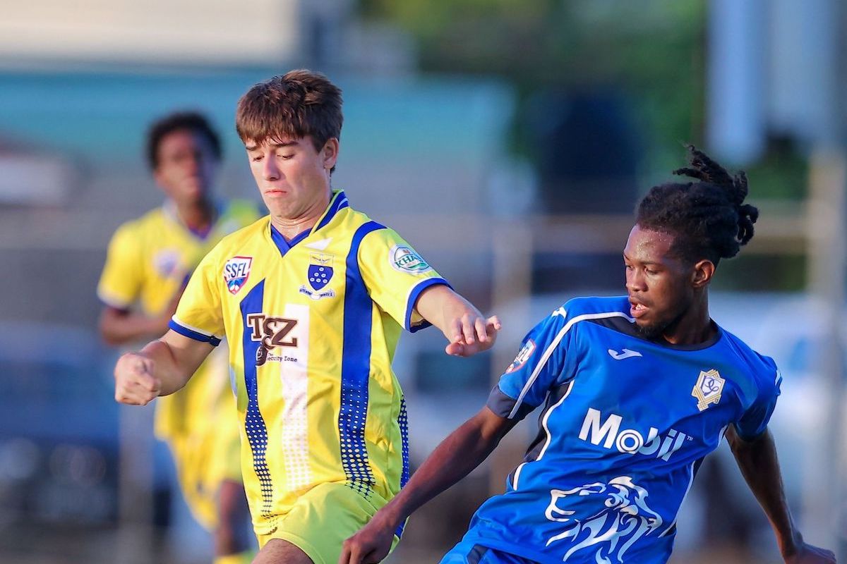 Presentation College San Fernando's defender Tyrel Pemberton, right, blocks Fatima College's Michael Chaves counter attack during the SSFL Premiership match at the Fatima College ground in Port-of-Spain on Wednesday, October 4th 2023. Presentation college won 1-0. PHOTO: Daniel Prentice