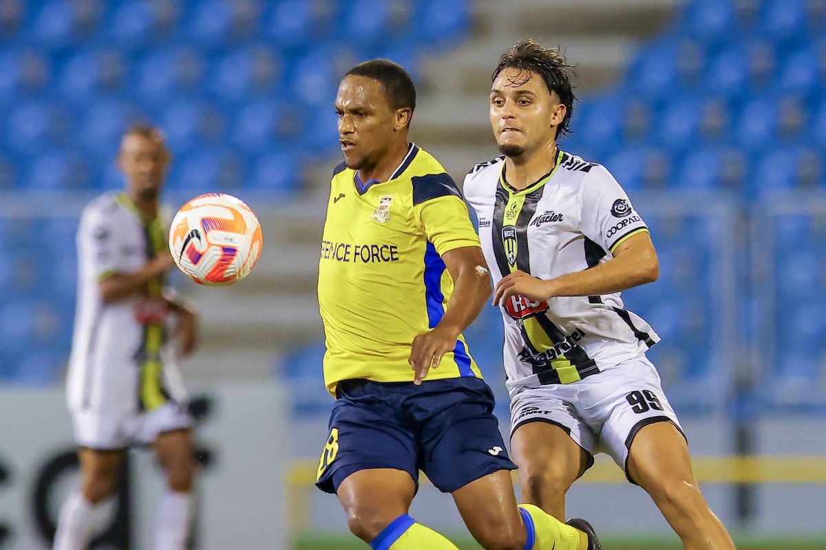 Defence Force FC’s Nathaniel Garcia, left, gets past Moca FC’s Michel Cardenas during the Concacaf Caribbean Cup at the Hasely Crawford Stadium on Wednesday, October 4th 2023 in Mucurapo, Port-of-Spain. PHOTO: Daniel Prentice