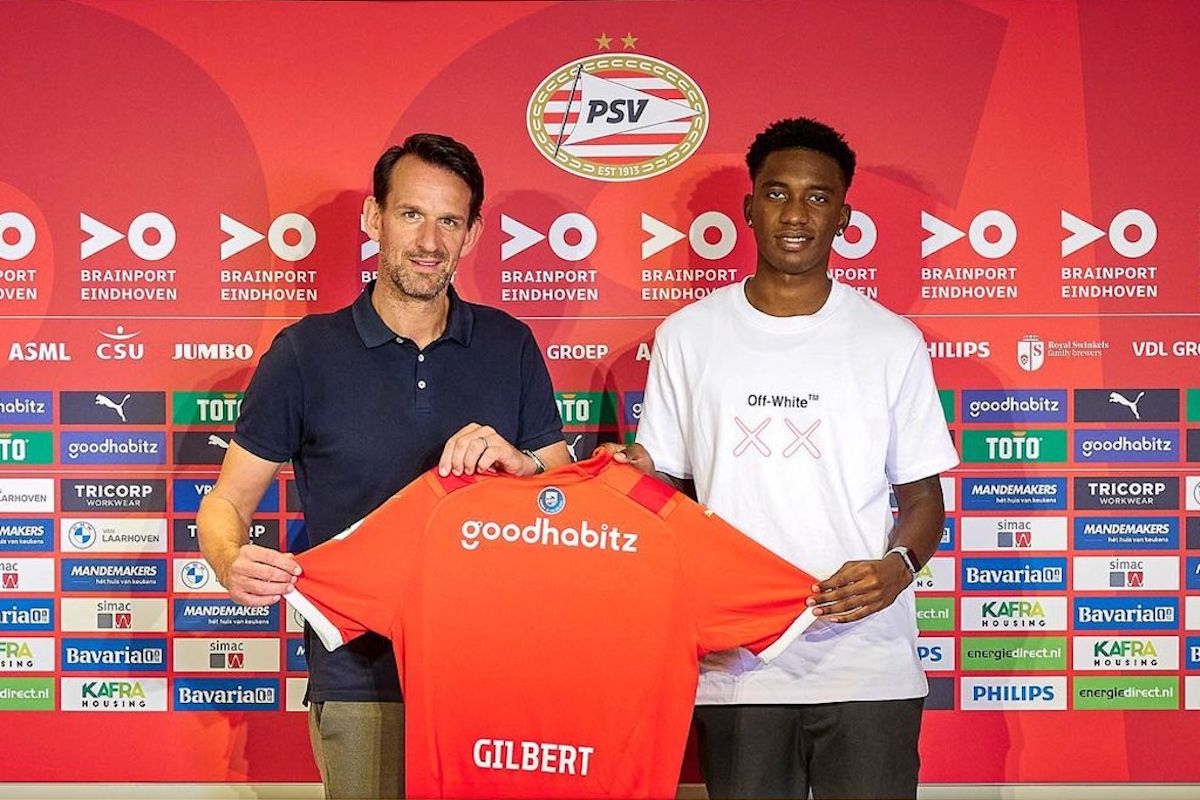 T&T's Dantaye Gilbert, right, gets his PSV Eindhoven jersey after signing for the Dutch club.