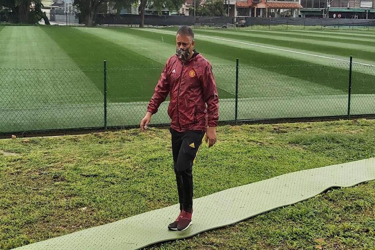 WALKING THE TALK: Commissioner of Police Gary Griffith surveys the new CCGrass multi-purpose astroturf that has been laid at the Police Barracks in St James. The preparation of the turf is nearing completion and is expected to be ready by month’s end. —Photo: MARK POUCHET
