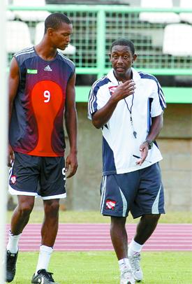 San Juan Jabloteh, midfielder, Ataullah Guerra, left, listens attentively to some words of advice from Soca Warriors coach, Russell Latapy during a national team training exercise at the Larry Gomes Stadium, Malabar, yesterday. Photo: Anthony Harris