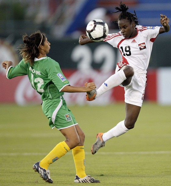 Kennya Cordner of Trinidad and Tobago (R) jumps for the ball with Katrina Moore of Guyana during the CONCACAF Women's World Cup qualifying soccer match at the Beto Avila stadium in Cancun November 2, 2010.