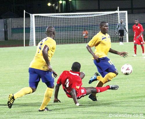 THAT'S St Ann's Rangers defender Elijah Belgrave making a high tackle on Defence Force striker Kevon Carter, right, which resulted in a broken leg for the Army-Coast Guard man. At left is Defence Force striker Devon Jorsling. Action was at the Mannie Ramjohn Stadium, Marabella, in the First Citizens Cup match. ...Author: ANIL RAMPERSAD
