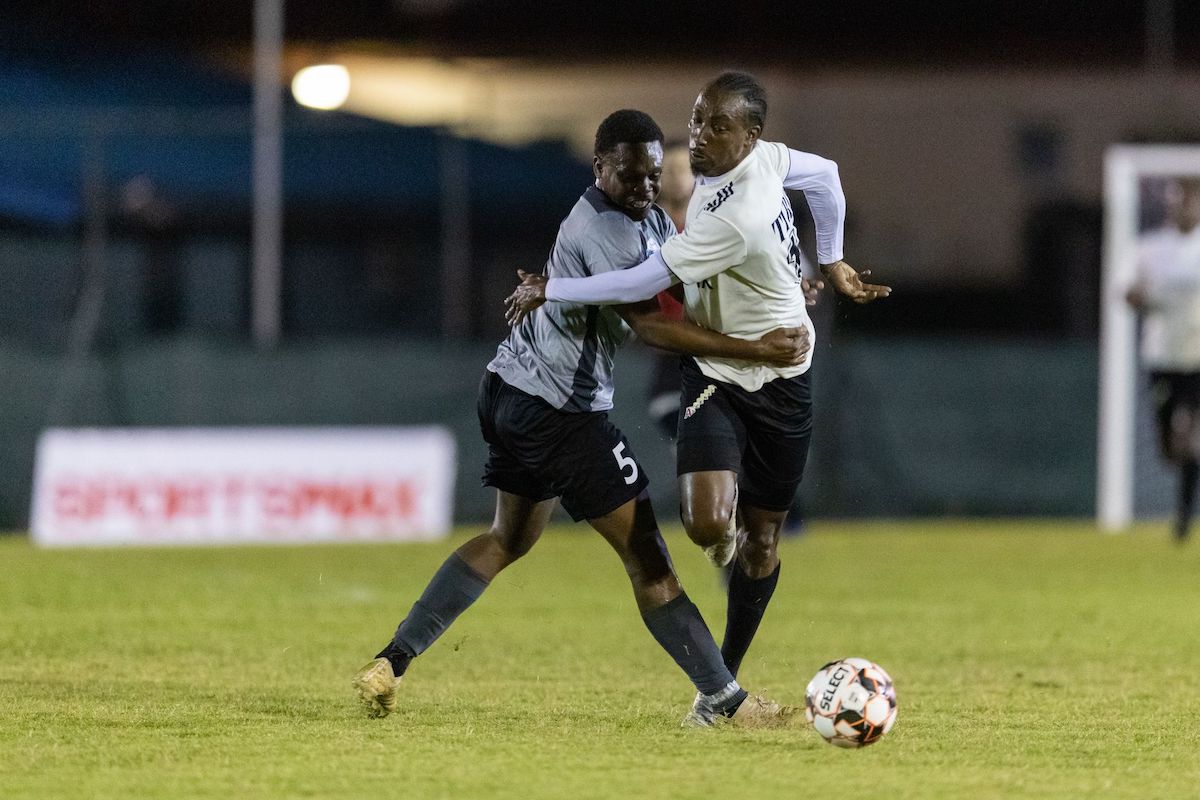 La Horquetta Rangers' Tyrone Charles, right, gets past the challenge from Police FC Keshawn Hutchinson (No.5) during the Ascension Tournament at the Phase 2 Recreation Grounds on April 1st 2022 in La Horquetta. Rangers won 4-2.