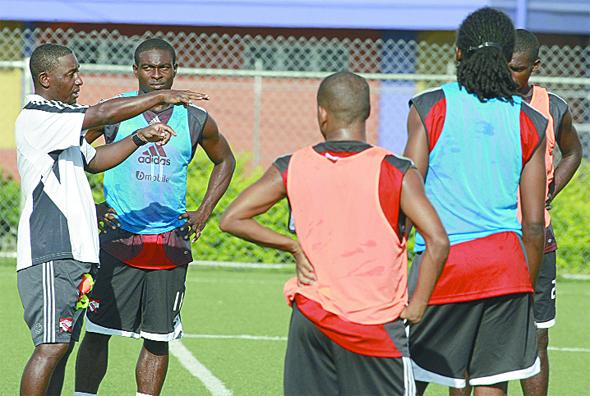 Soca Warriors coach, Russell Latapy, left, has the full attention of players from left, Kevon Carter, Clyde Leon (mostly hidden), Keon Daniel and Hayden Tinto during yesterday’s tarining session at the Marvin Lee Stadium, Macoya ahead of today’s match against Jamaica at the same venue from 6 pm. (Photo Credit: Anthony Harris of the T&T Guardian).