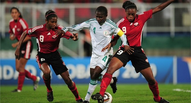 Oluchi Ofoegbu of Nigeria is challenged by Liana Hinds and Victoria Swift of Trinidad & Tobago during the FIFA U17 Women's World Cup Group A match between Trinidad & Tobago and Nigeria at the Manny Ramjohn Stadium on September 8, 2010 in Marabella, Trinidad And Tobago. (Photo by Shaun Botterill - FIFA/FIFA via Getty Images)