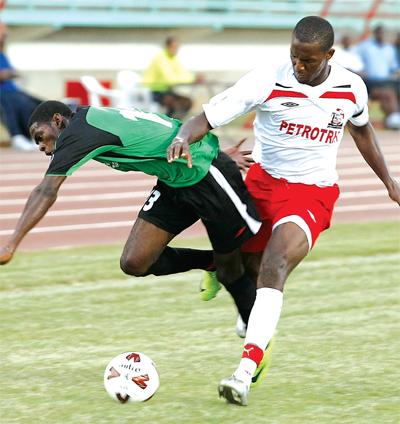 Makan Hislop, right, of United Petrotrin puts in a strong tackle on Clico San Juan Jabloteh’s Jason Marcano during a Digicel Pro League match at the Larry Gomes Stadium, Malabar, last October. ...PHOTO: ANTHONY HARRIS.