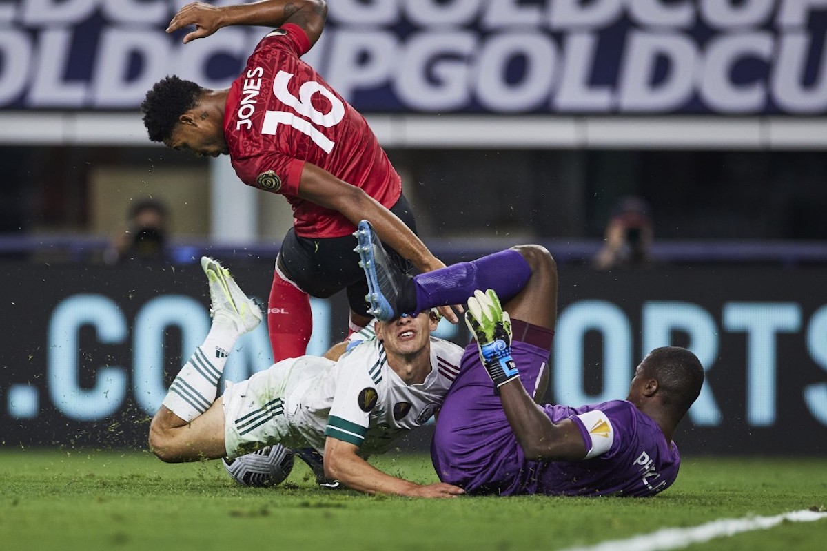Trinidad and Tobago goalkeeper Marvin Phillip (#1) collides with Mexico forward Hirving Lozano (#22) during the first half of a CONCACAF Gold Cup group stage match at AT&T Stadium, Arlington, Texas on July 10th 2021