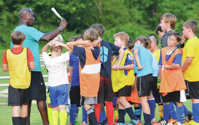 Keita Placide calls out some instruction during a youth soccer camp