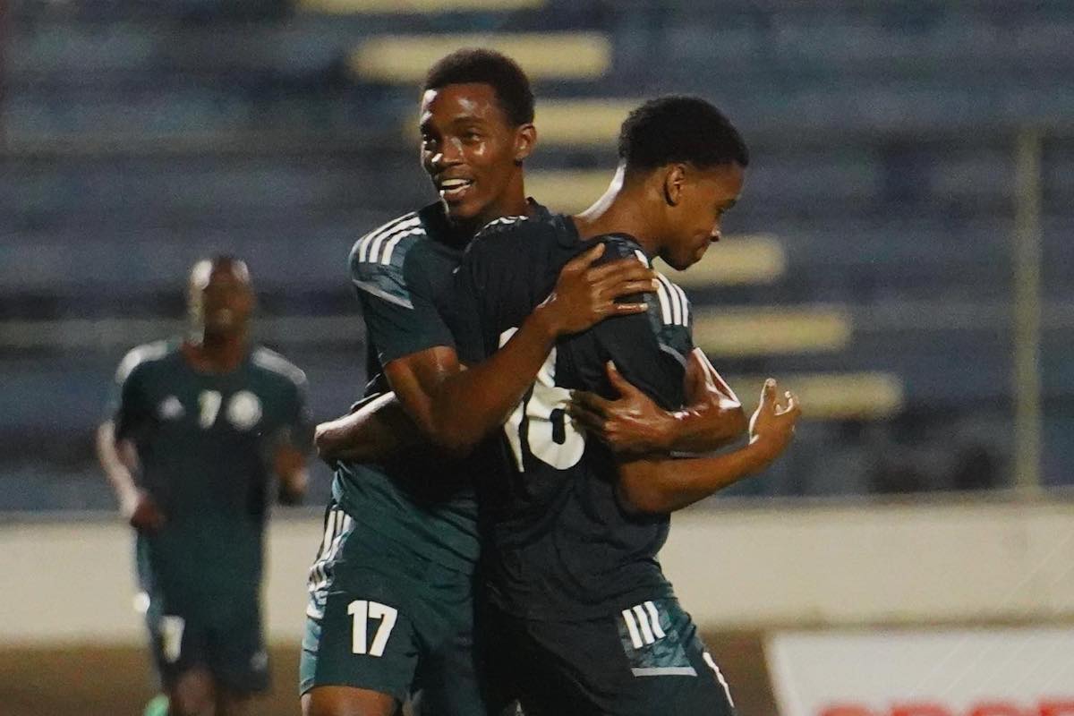 Prison Service FC's Jeremiah Vidale (right) is congratulated by teammates after scoring the game-winner in a 2-1 victory over Morvant Caledonia United at the Arima Velodrome on Sunday, January 14th 2024.