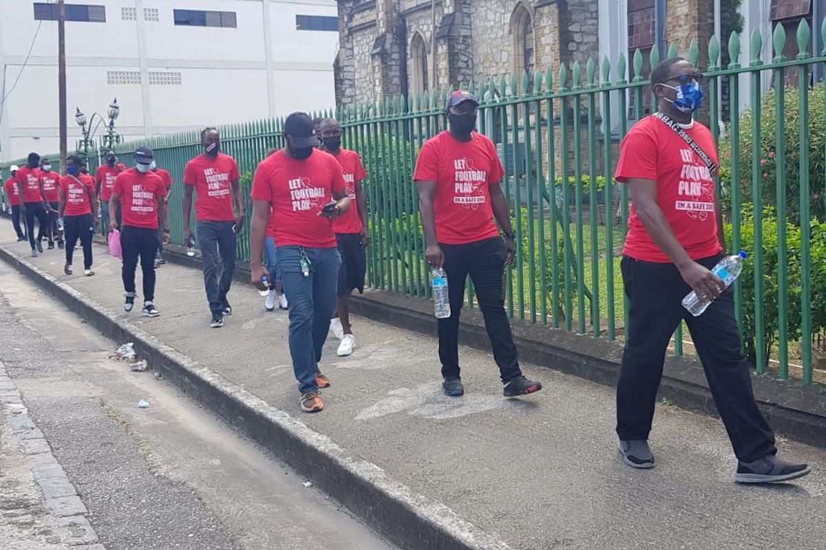Members of the group of Footballer stakeholders walked along Hart Street in Port-of-Spain in protest of not being allowed to play football. They want Government to allowed football to play in safe zones.