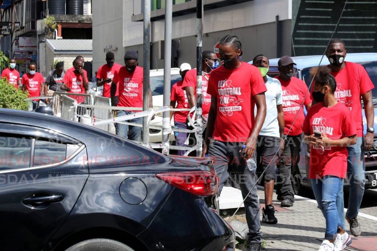 Footballers, coaches and supporters walk through Port of Spain, on Thursday, over the shutdown of sports due to the coronavirus pandemic. - SUREASH CHOLAI