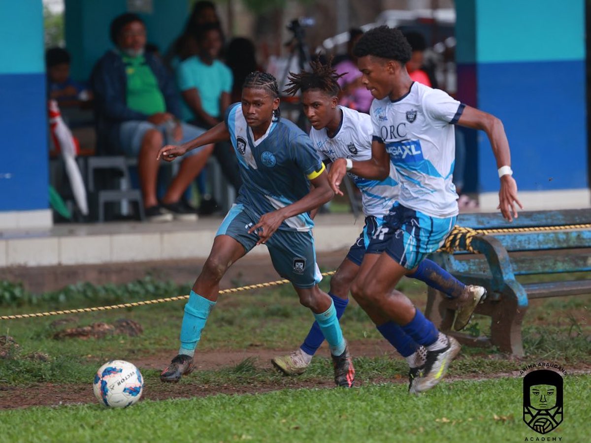 Arima North Secondary Captain Jemaul Ashing (left) is chased by two QRC players during an SSFL match at QRC Grounds, St. Clair, Port of Spain on Friday, November 3rd 2023.