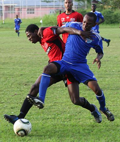 Defence Force’s Richard Roy, right, wins the battle for the ball ahead of St Ann’s Rangers’ Kareem Moses in their Digicel T&T Pro League match at the Larry Gomes Stadium, Malabar, on Tuesday night. Roy scored a hat-trick in his team’s 3-1 win.