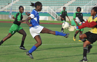 WHAT A BLOCK!: Roxborough Secondary goalkeeper Shanice Sylvester, right, does well to keep out this shot from Debe Secondary midfielder Amanda Theodore in Monday's BG T&T/First Citizens Secondary Schools Football League 