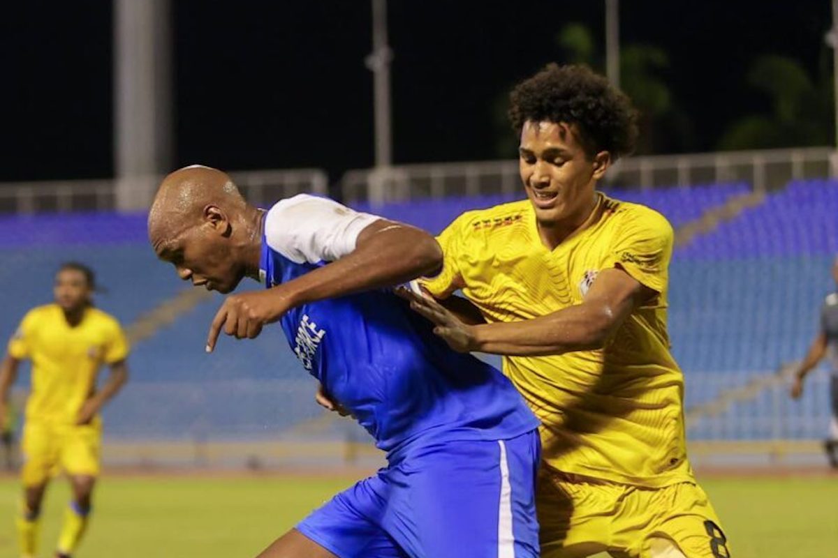 Defence Force FC Brent Sam (L) holds off Athletic Club PoS' Michel Poon Angeron during the Concacaf Caribbean Cup at the Hasely Crawford Stadium on Thursday, September 28th 2023 in Port of Spain. The match ended 1-1. PHOTO: Daniel Prentice