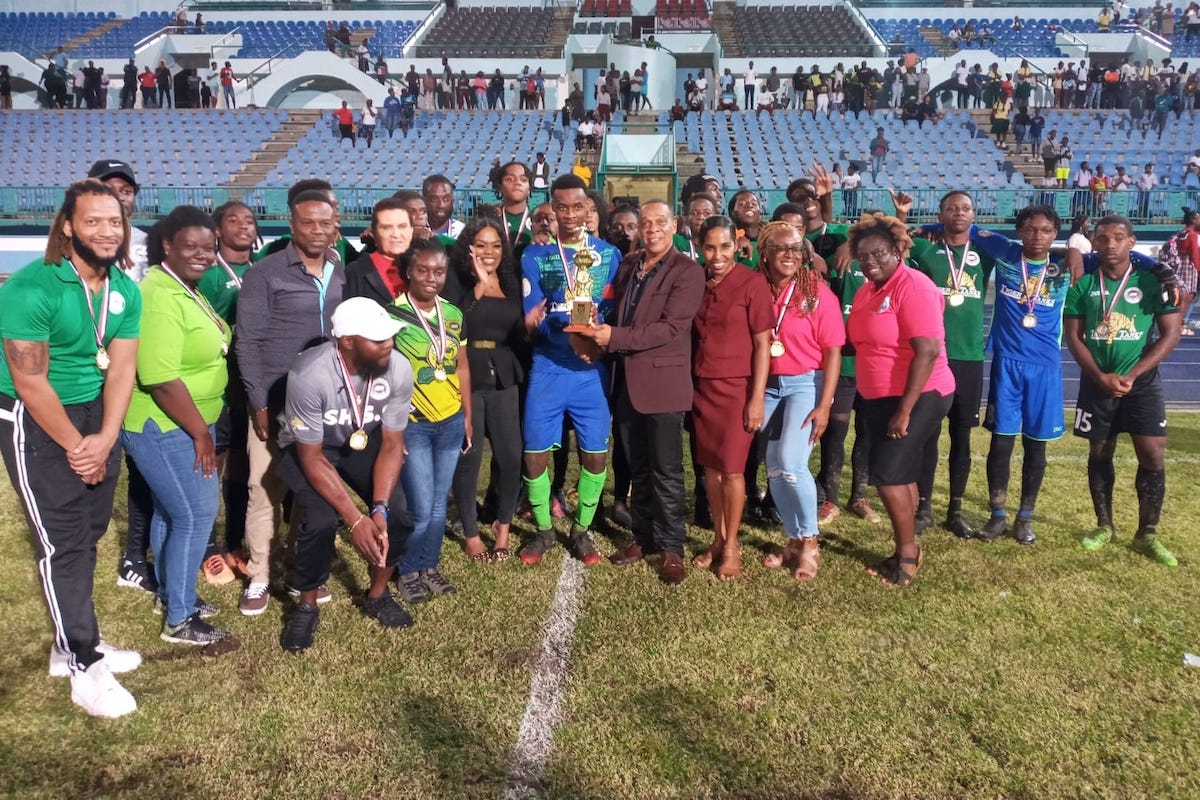 Kareem Warner ( goalkeeper ) Signal Hill Secondary receives the COCA COLA trophy after his team defeated Mason Hall Secondary 6-5 with Kicks from the Penalty Mark in the Tiger Tanks SSFL COCA COLA Intercol Tobago Zone final after they were 1-1 at the end of full time....Tuesday 22nd November, 2022 at the Dwight Yorke stadium.