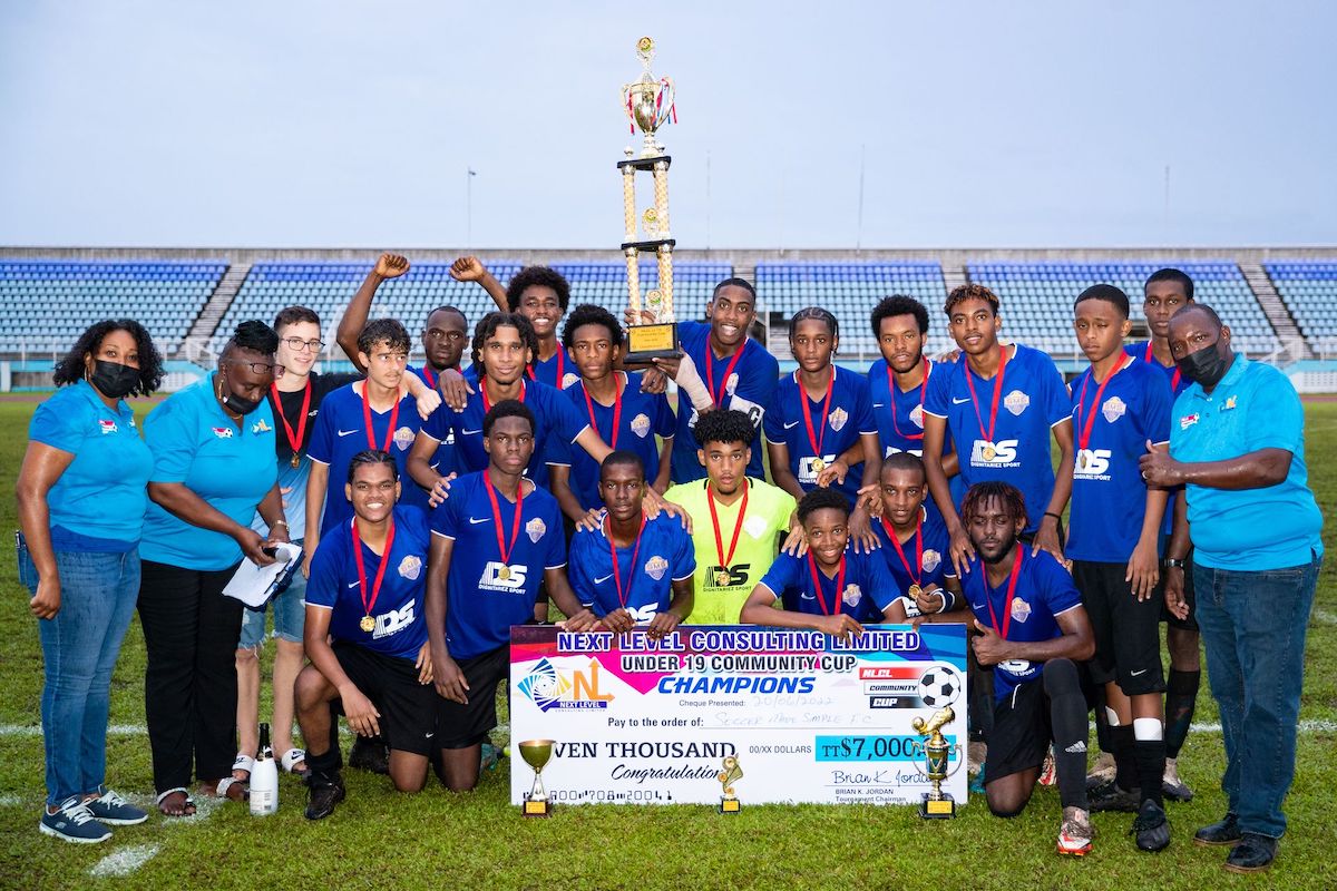 Soccer Made Simple with the winners’ trophy and cheque after defeating Cox Academy in the NLCL Under-19 Community Cup Final at the Ato Boldon Stadium in Couva. Soccer Made Simple won 4-1. PHOTO: Daniel Prentice