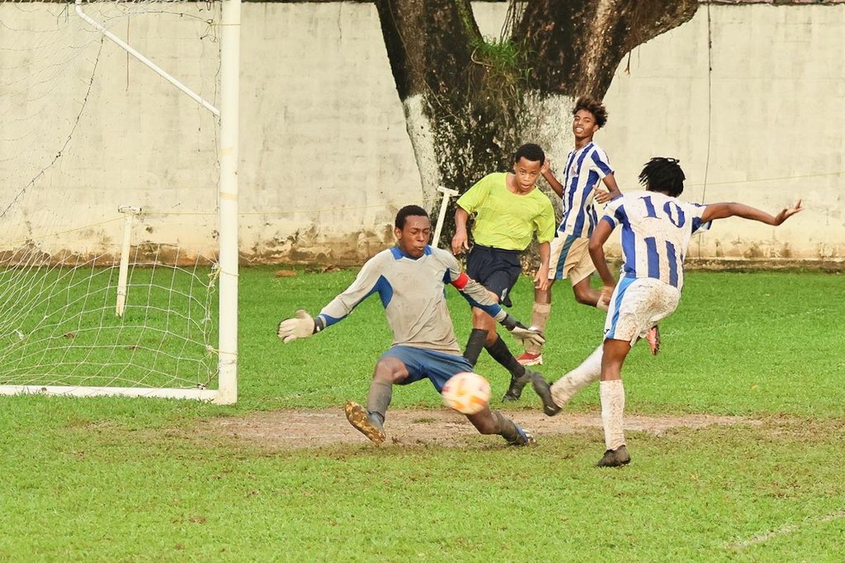 Belmont Secondary School's goalkeeper Tyrese Henry attempts to stop a shot off St Mary's College Marley Callender during their Intercol match at the St Mary's Grounds, Serpentine Road, Port-of-Spain on Monday, November 6th 2023..