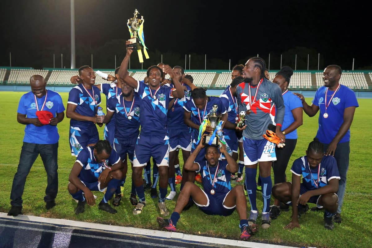Stokely Vale celebrates after winning the TFA FA Cup over Sidey's SC at Dwight Yorke Stadium, Bacolet, Tobago on Sunday, October 8th 2023. Captain Calvin Chapman holds up the trophy whle Head Coach James Campbell on the extreme left, enjoys the moment.