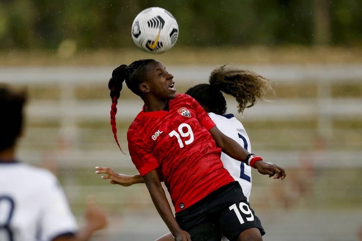 T&T's Kennya Cordner goes up high for an airball under challenge from Dominican Republic's Brianne Reed during their international friendly encounter in San Cristobal in November 2021. The match ended 1-1.