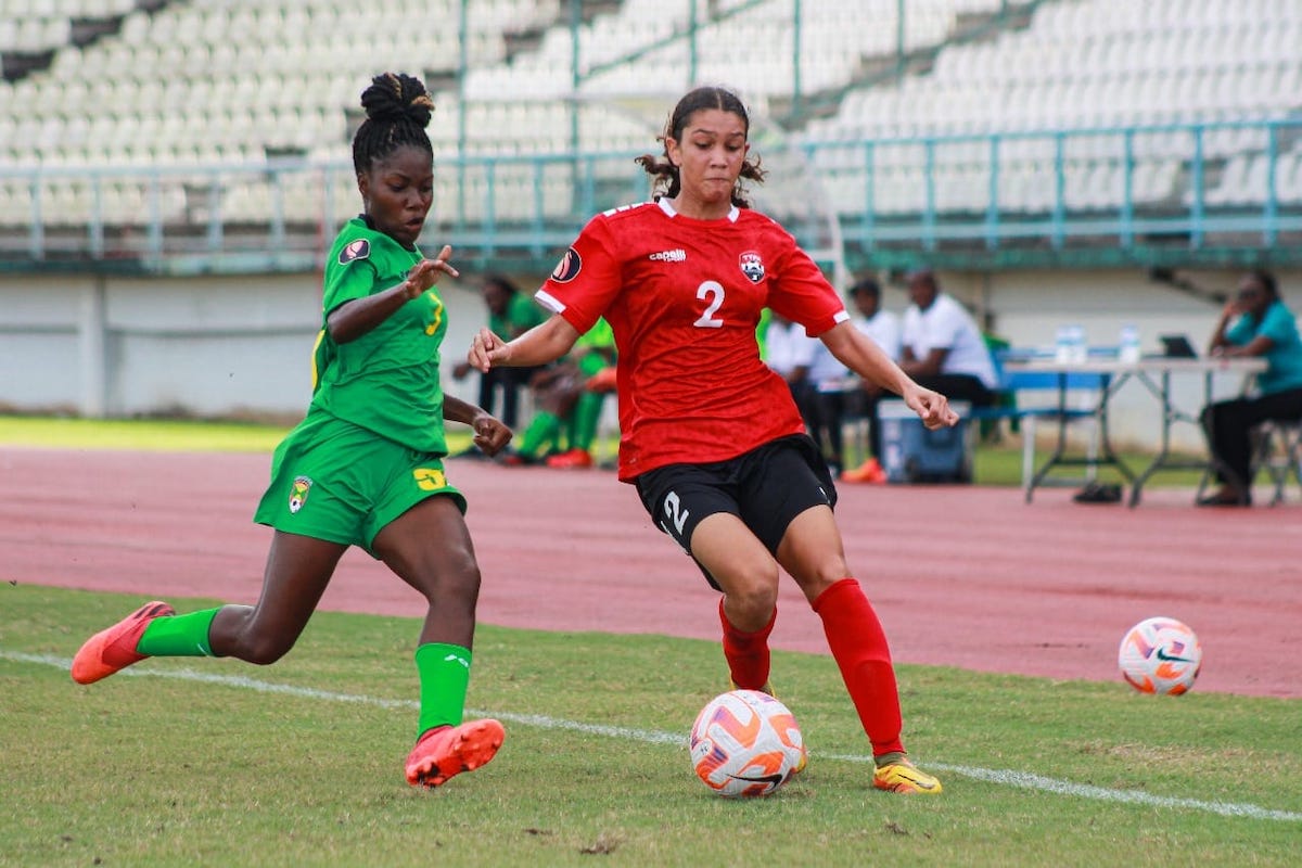 Trinidad and Tobago's Kaitlyn Darwent (right) is challenged for the ball by a Grenadian player during a Jewels of the Caribbean  Women's U-17 Invitational Tournament match at Larry Gomes Stadium, Malabar on Saturday, December 16th 2023.