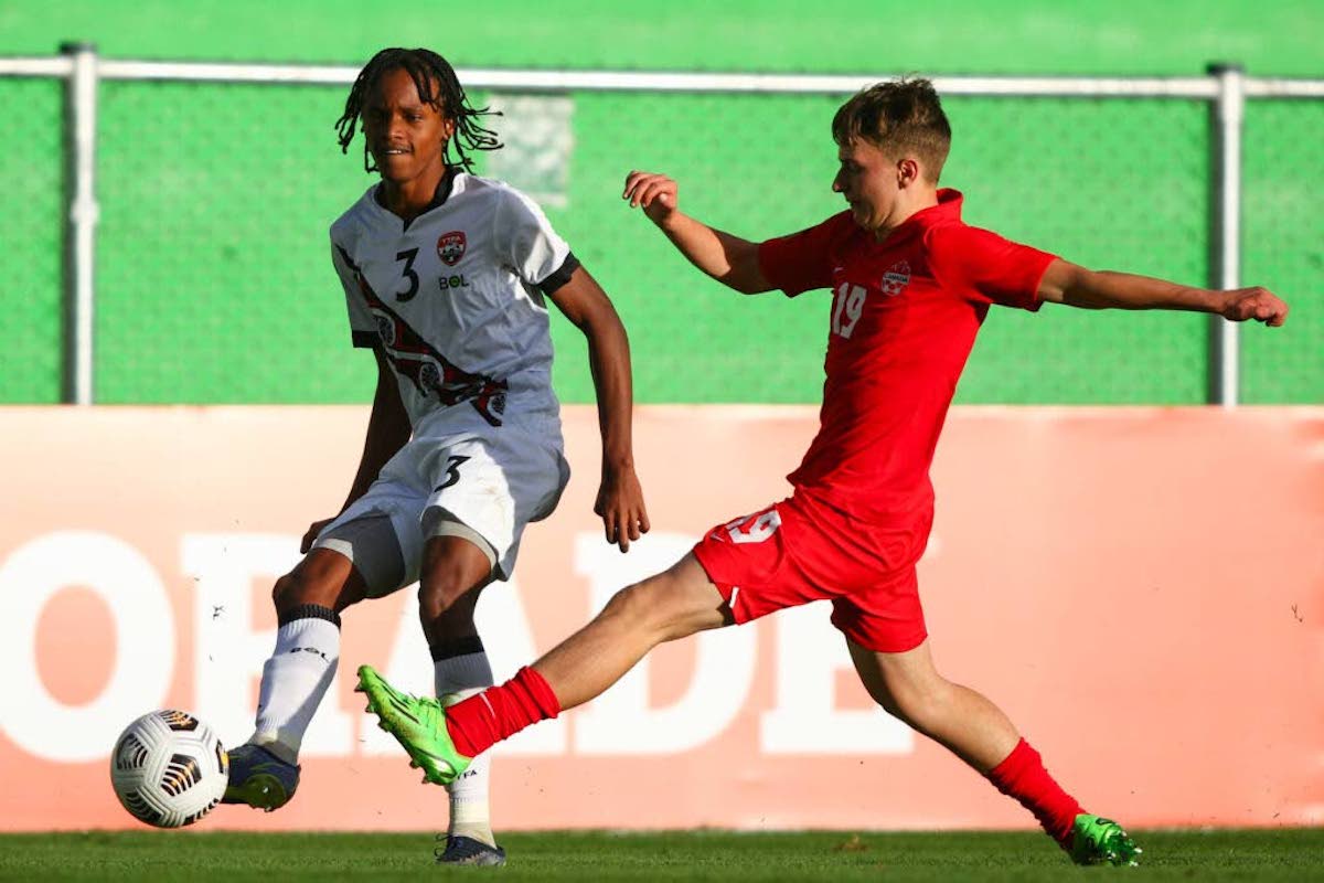 Joshua Figaro of T&T, left, competes for the ball with Kyler Vojvodic of Canada during the Group F match between the teams in the CONCACAF Men's Under-17 Championship, held at the Pensativo stadium, in Antigua City, Guatemala on Saturday, February 11th 2023.