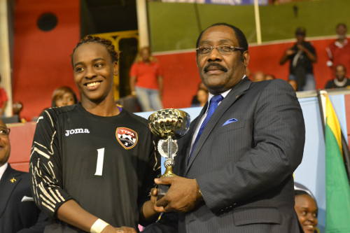 Kimika Forbes receives the Caribbean Cup Best Goalkeeper prize from Horace Burrell. 