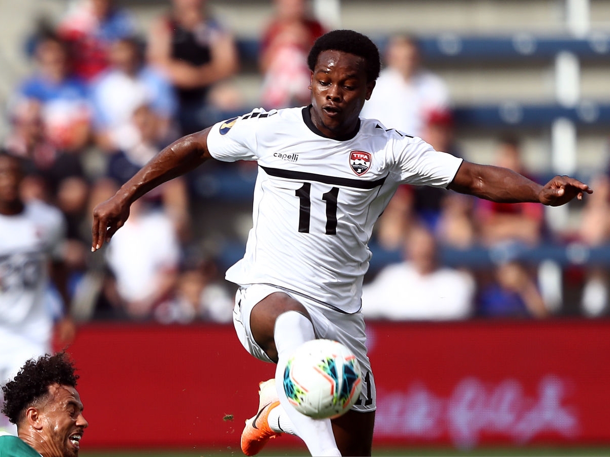 Levi Garcia of Trinidad and Tobago controls the ball as Terence Vancooten of Guyana attempts to slide tackle during the first half of the CONCACAF Gold Cup match at Children's Mercy Park on June 26, 2019 in Kansas City, Kansas. (Photo by Jamie Squire/Getty Images)