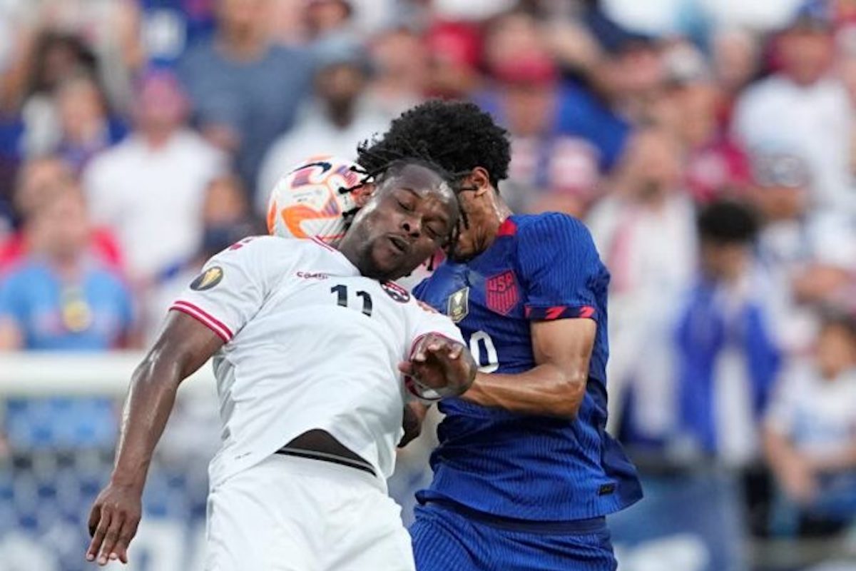 T&T forward Levi García (L) heads the ball away form United States defender Jalen Neal during the first half of a Concacaf Gold Cup match on Sunday July 2nd 2023, in Charlotte, NC. - AP PHOTO