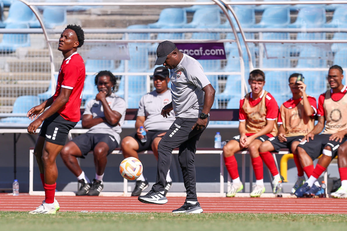 Trinidad and Tobago Head Coach Angus Eve (center) juggles the ball on the sidelines during an International Friendly match against Jamaica at the Hasely Crawford Stadium, Port of Spain on Friday, March 1st 2024.