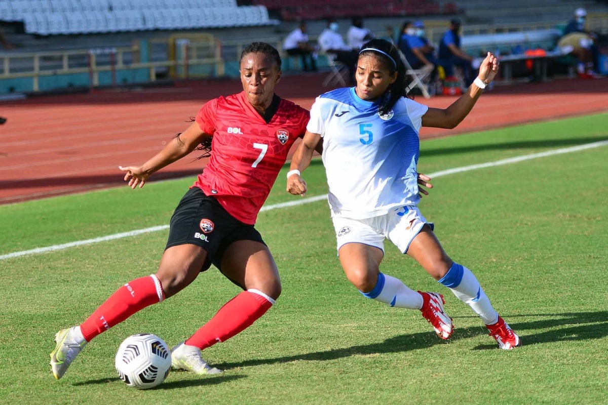 Trinidad and Tobago midfielder Liana Hinds (#7) battles for the ball with Nicaragua's Lisbeth Moreno (#5) during a 2022 Concacaf Women's Championship Qualifier at the Ato Boldon Stadium, Couva, Trinidad and Tobago on February 17th 2022.
