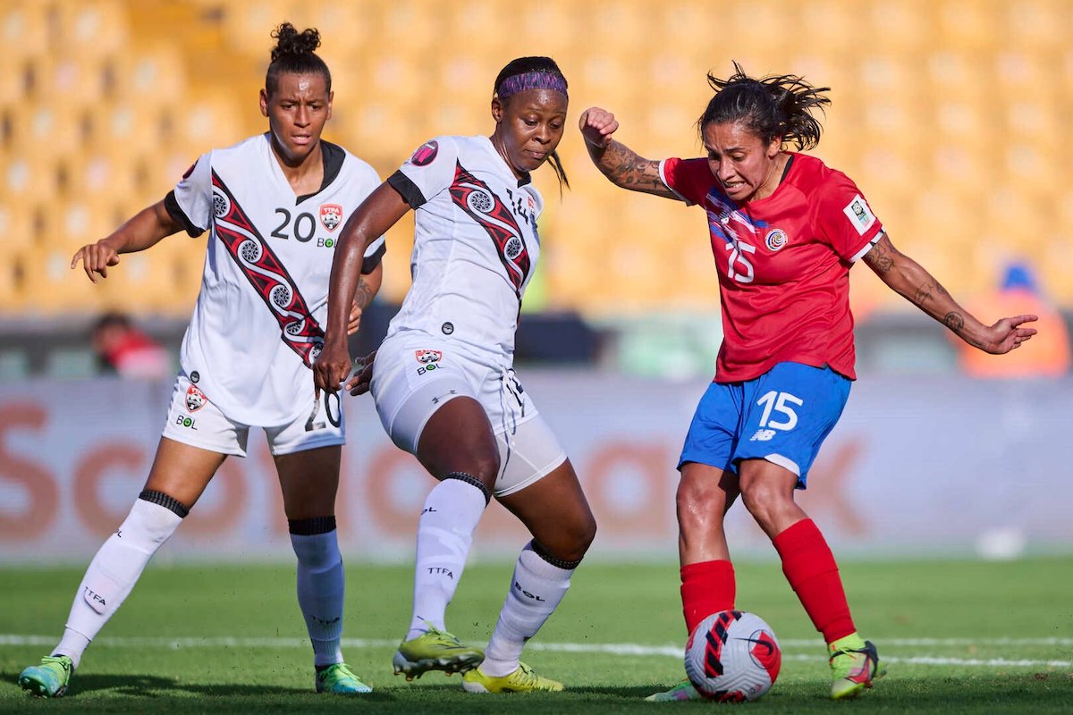 Trinidad and Tobago captain Karyn Forbes (#14) challenges Costa Rica's Cristin Granados (#15) for the ball while Lauryn Hutchinson (#20) watches on during a Group B match at the 2022 CONCACAF Women's Championship at the Estadio Universitario in Nuevo León, Mexico on Friday, July 8th 2022.