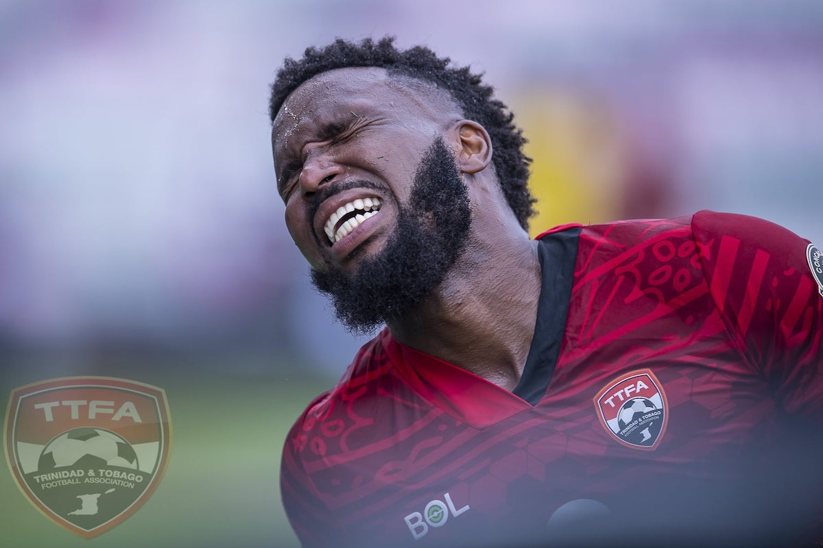 Trinidad and Tobago captain Khaleem Hyland grimaces in pain during a 2021 Concacaf Preliminary Second Round match against French Guiana at DRV PNK Stadium, Ft. Lauderdale, FL on Tuesday, July 6th 2021.