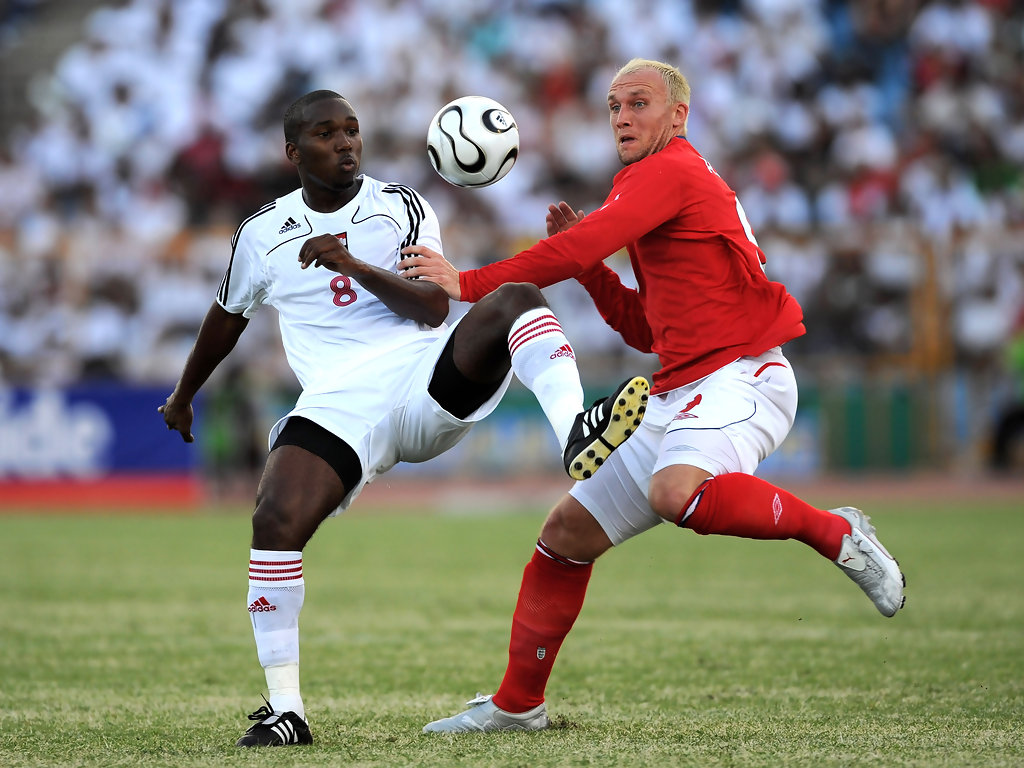 Dean Ashton of England is challenged by Khaleem Hyland of Trinidad during international friendly between Trinidad & Tobago and England at the Hasely Crawford Stadium on June 1, 2008 in Port of Spain, Trinidad.