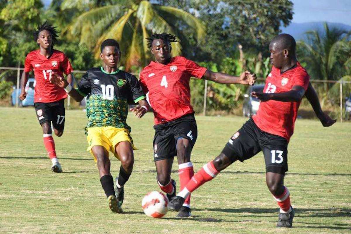 Jamaica's Jahmani Bell (second left) closes for a challenge on the Trinidad and Tobago pair of Lyshaun Morris (second right) and Jaden Williams during their Under-17 friendly contest in Santa Cruz on Tuesday, February 7th 2023. (Photo: Garfield Robinson)