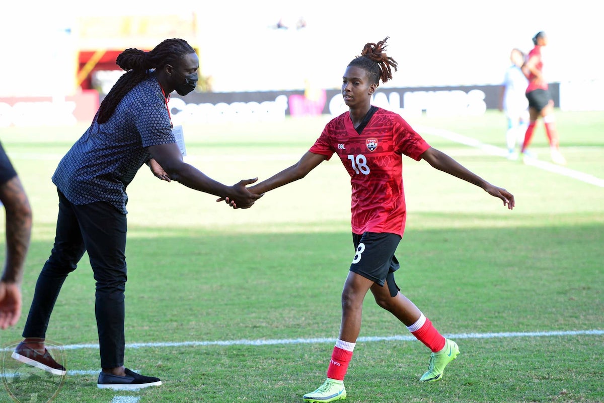 Trinidad and Tobago Women's Head Coach Kenwyne Jones shakes the hand of Maria-Frances Serrant as she is substituted during a match against Nicaragua on February 17th 2022 ash the Hasely Crawford Stadium, Port of Spain, Trinidad and Tobago