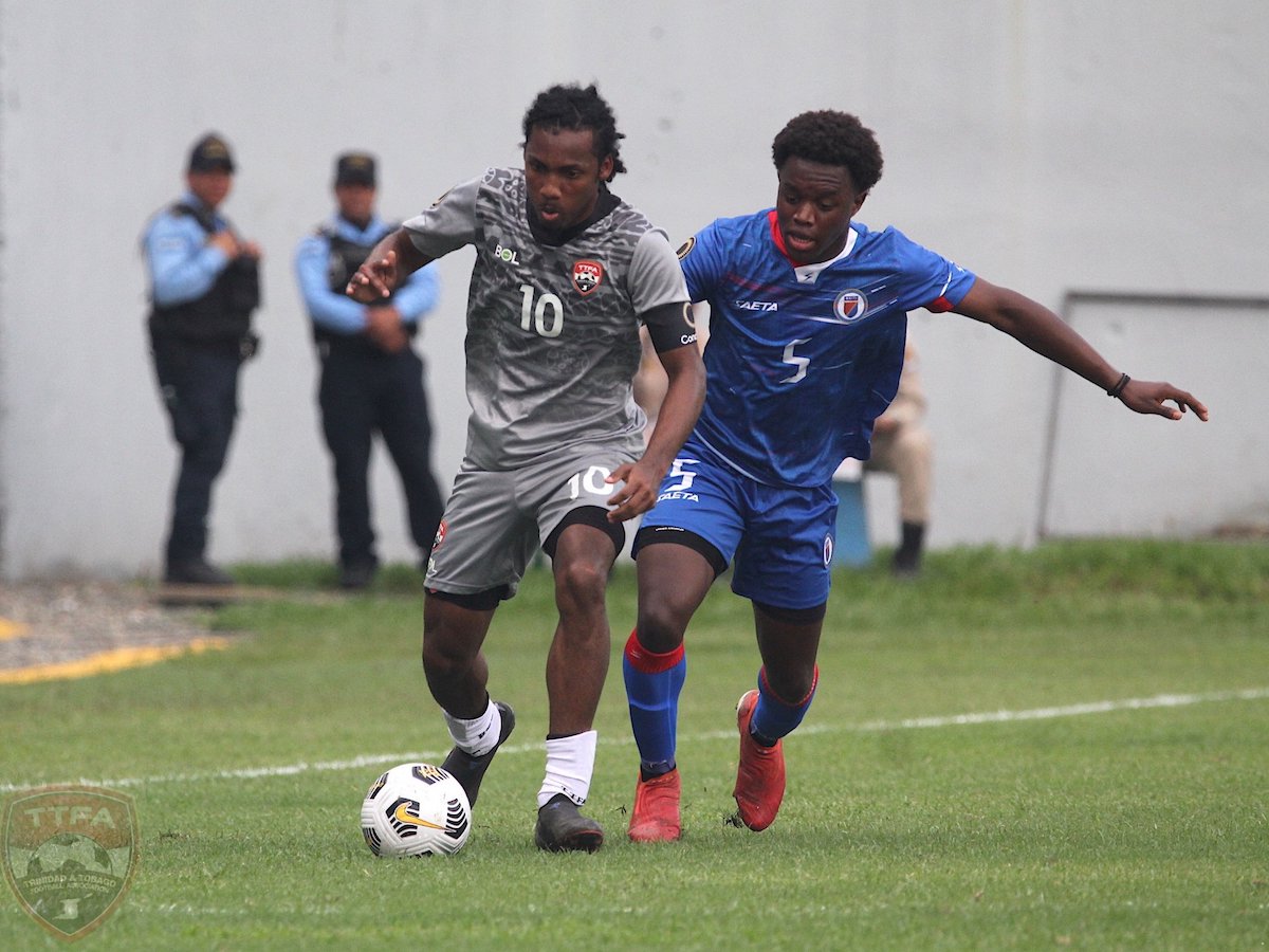 Trinidad and Tobago U-20 captain Molik Khan (#10) battles with Haiti's Woodensky Pierre (#5) during a 2022 Concacaf Men's U-20 Championship match at the Estadio Francisco Morazán, San Pedro Sula, Honduras on Sunday, June 19th 2022