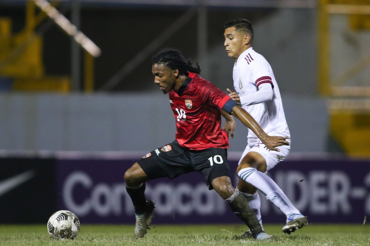Trinidad and Tobago U-20 captain Molik Khan (#10) battles with a Mexican opponent during a 2022 Concacaf Men's U-20 Championship match at the Estadio Francisco Morazán, San Pedro Sula, Honduras on Tuesday, June 22nd 2022